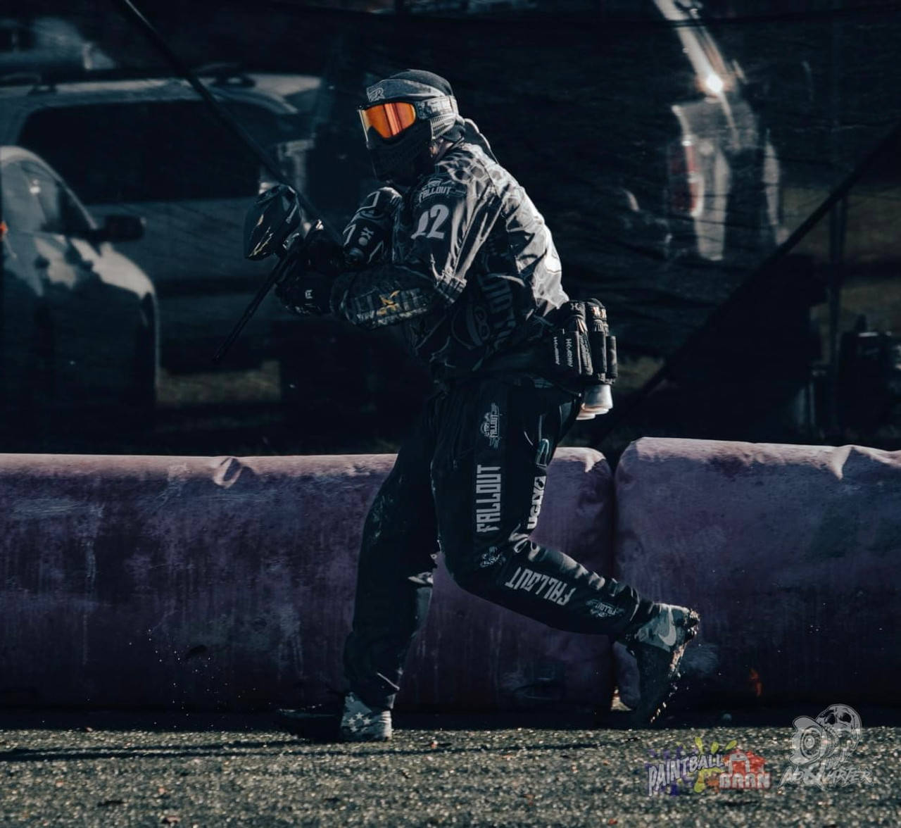 Maneuvering Paintball Player In Dark Colored Gear Wallpaper