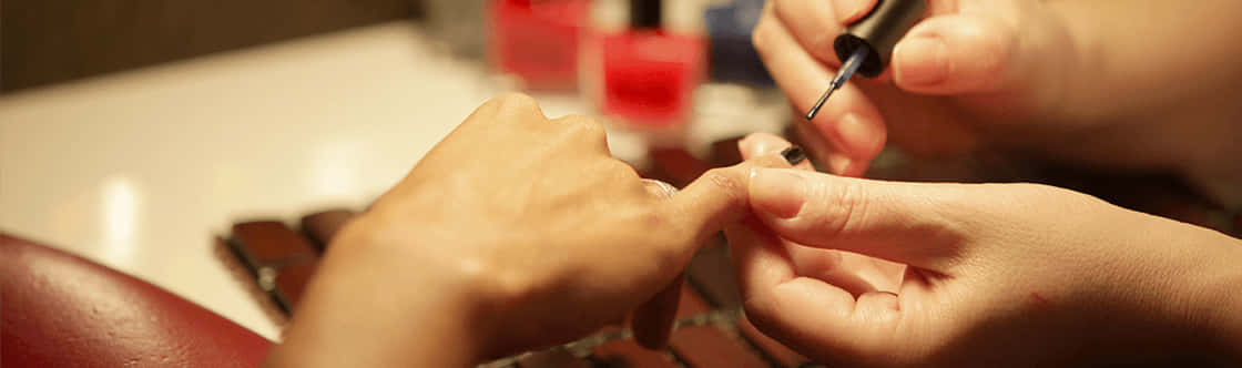 A Woman Getting Her Nails Done At A Salon