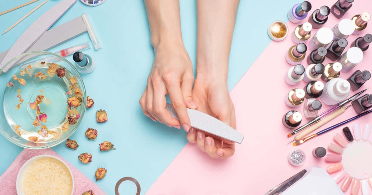 A Woman Is Holding A Nail File And Other Nail Care Products