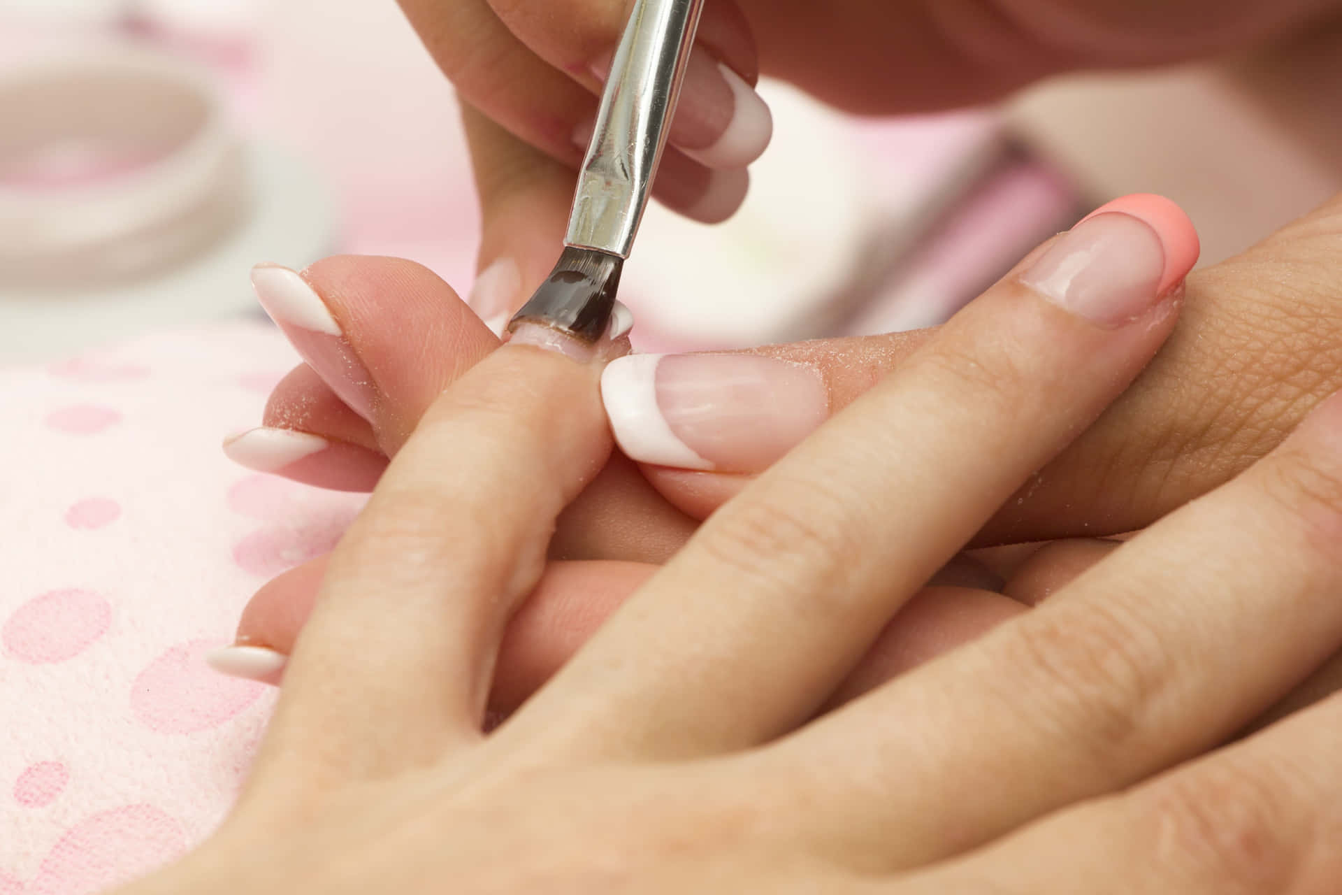 A Woman Is Getting Her Nails Done At A Nail Salon
