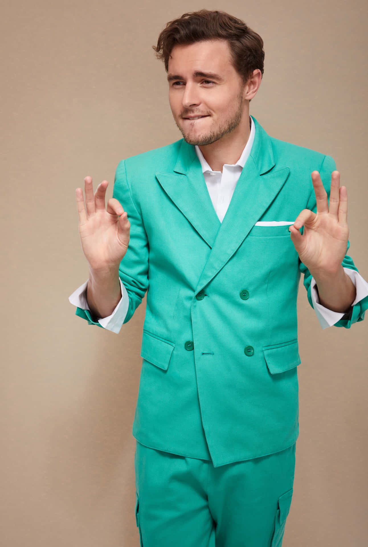 Manin Green Suit Gesturing O K Wallpaper