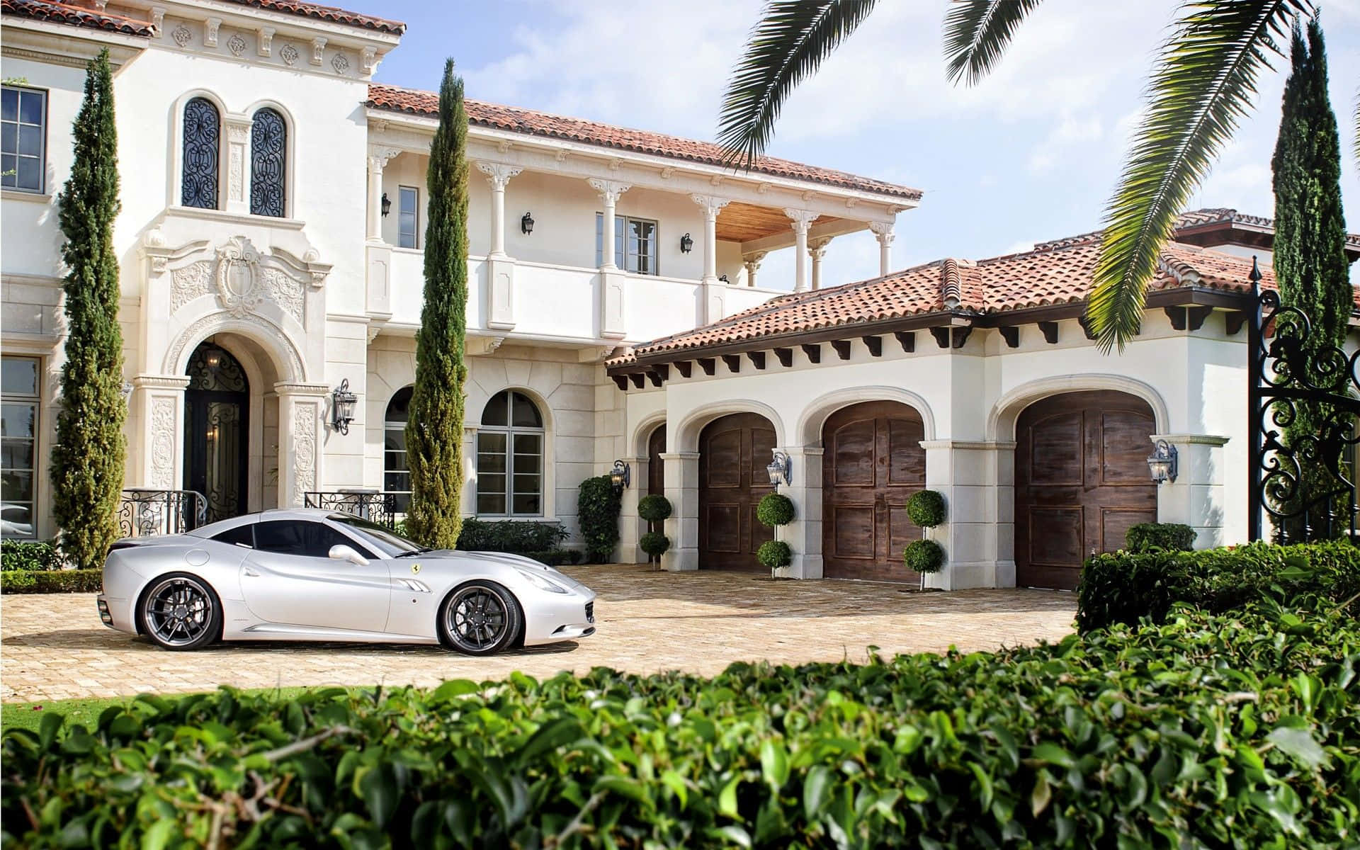 A White Sports Car Parked In Front Of A Mansion