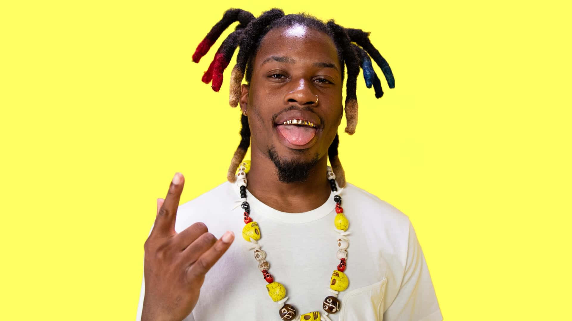 Manwith Dreadlocks Tongue Out Rock Sign Wallpaper