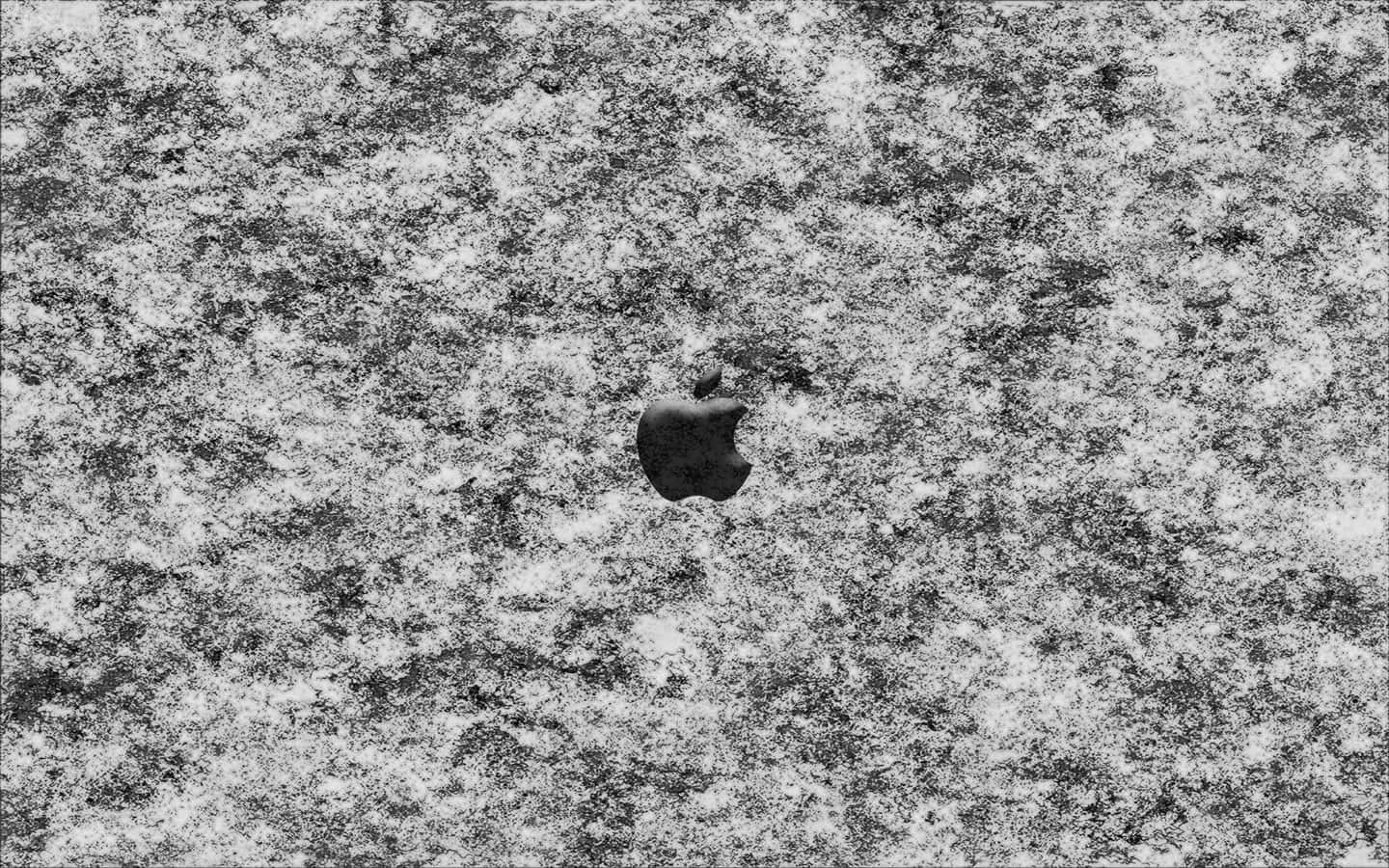A Black And White Photo Of An Apple Logo On A Snowy Surface Wallpaper