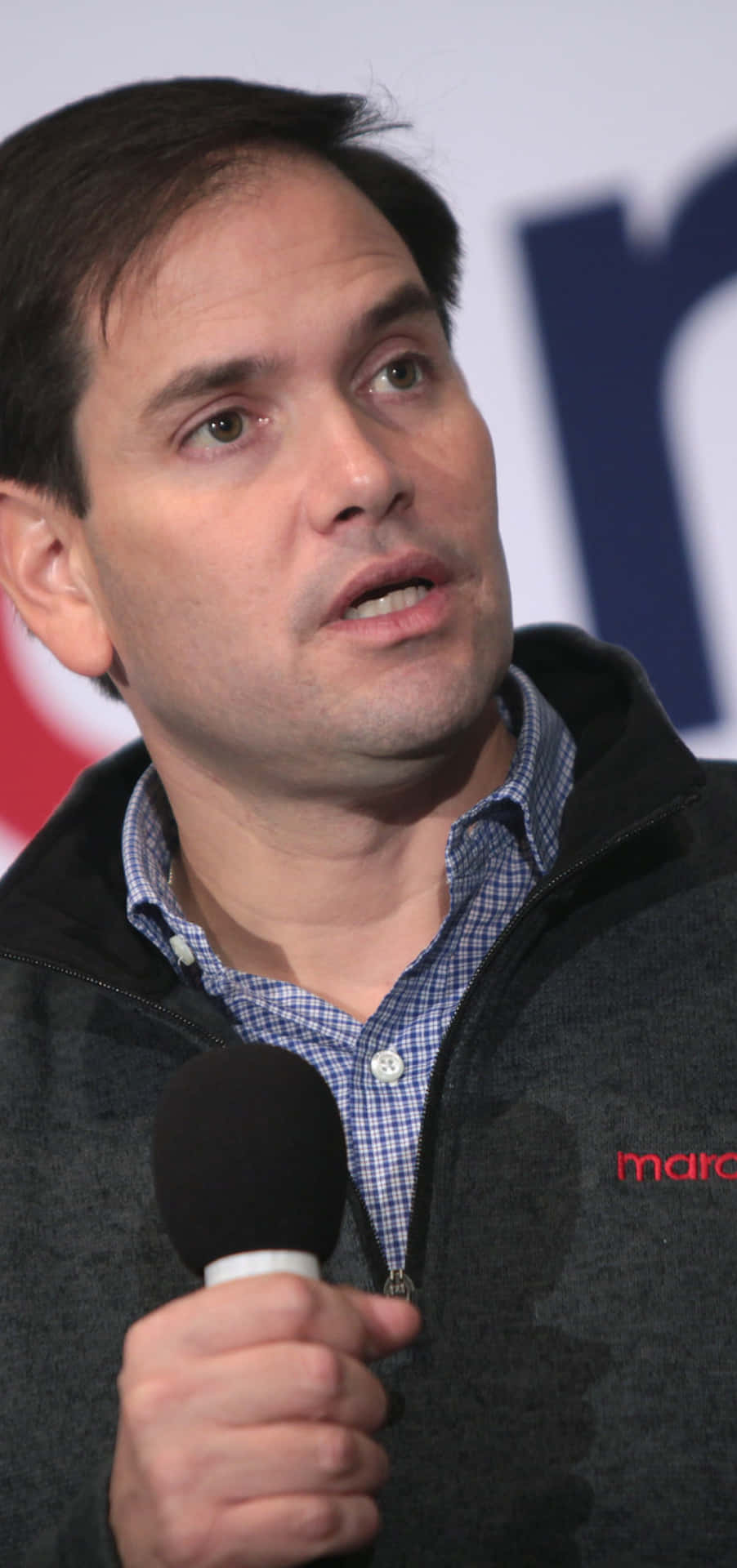 Senator Marco Rubio passionately addressing an audience with a microphone Wallpaper