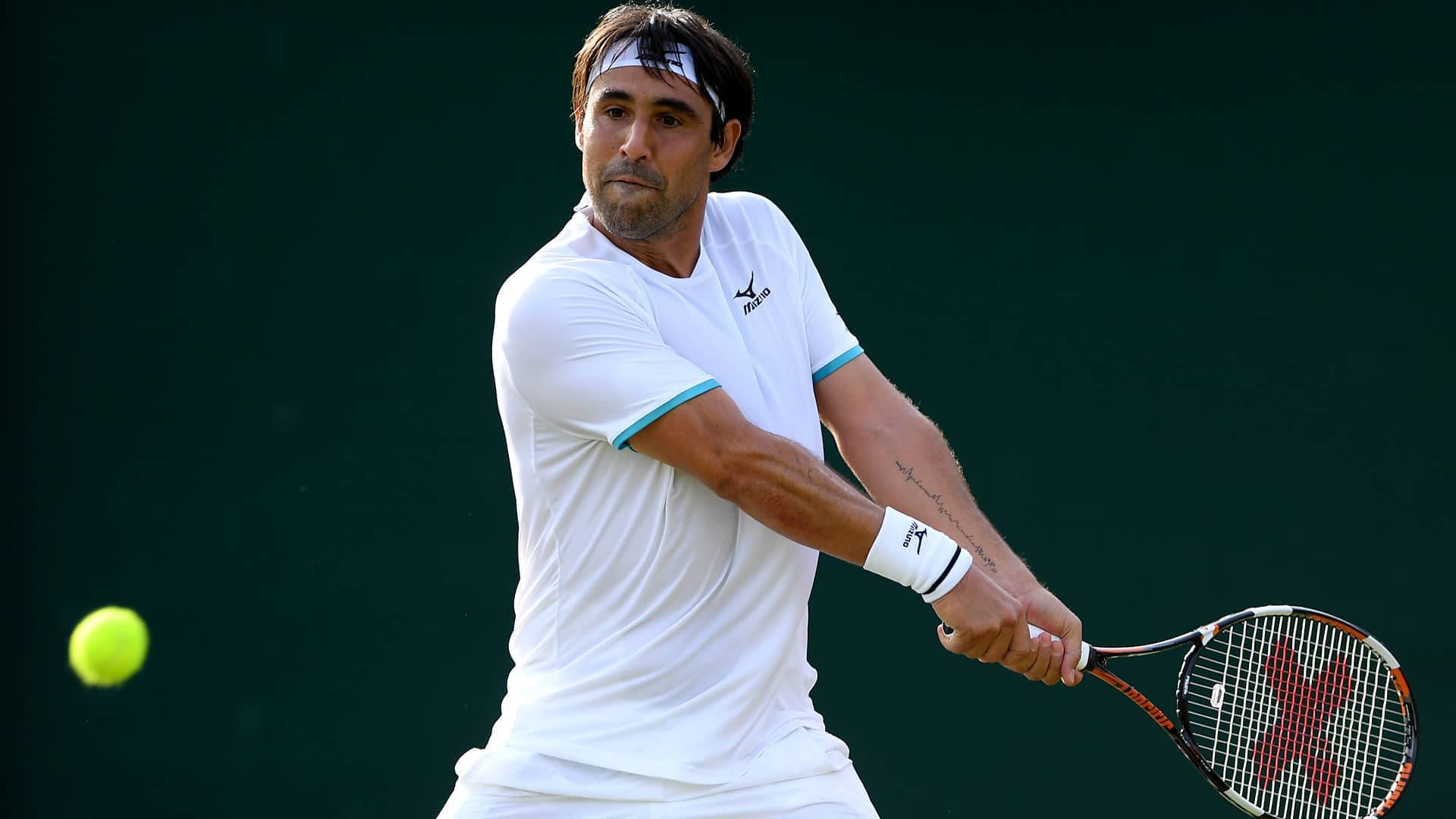 Marcos Baghdatis expertly preparing to counter an incoming ball during a tennis match. Wallpaper