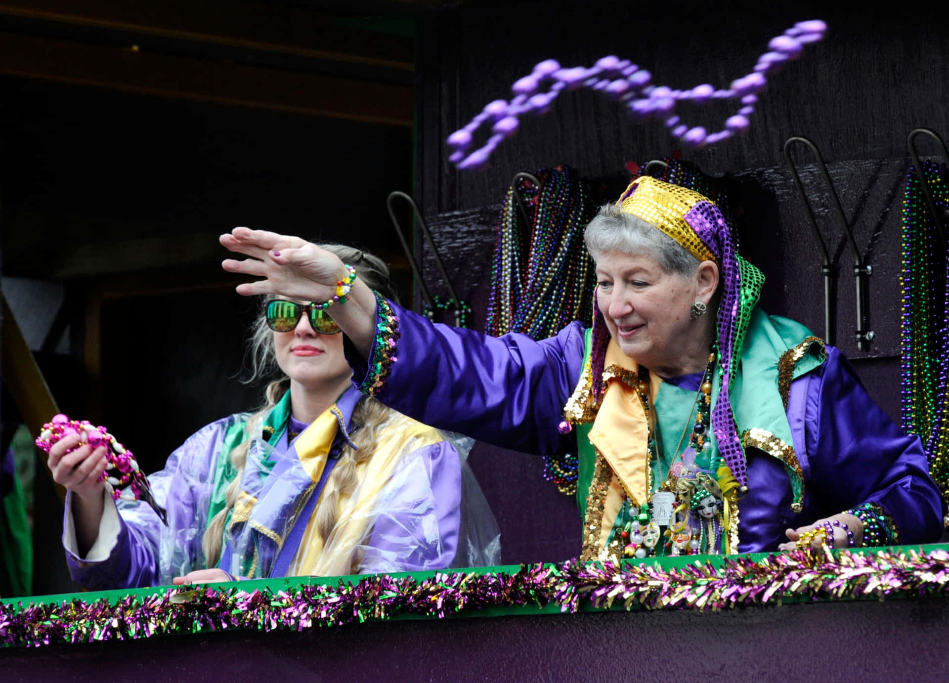 Two Women Wearing Purple And Green