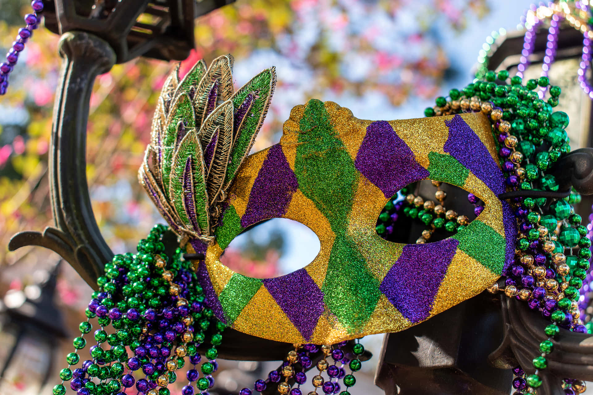 Mardi Gras Masks And Beads On A Pole