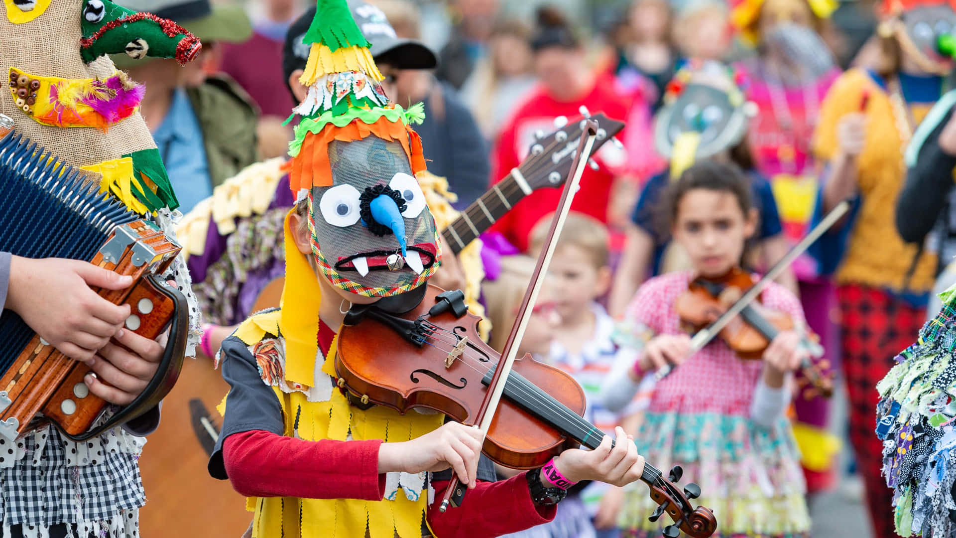 A Group Of People Dressed Up In Costumes Playing Instruments