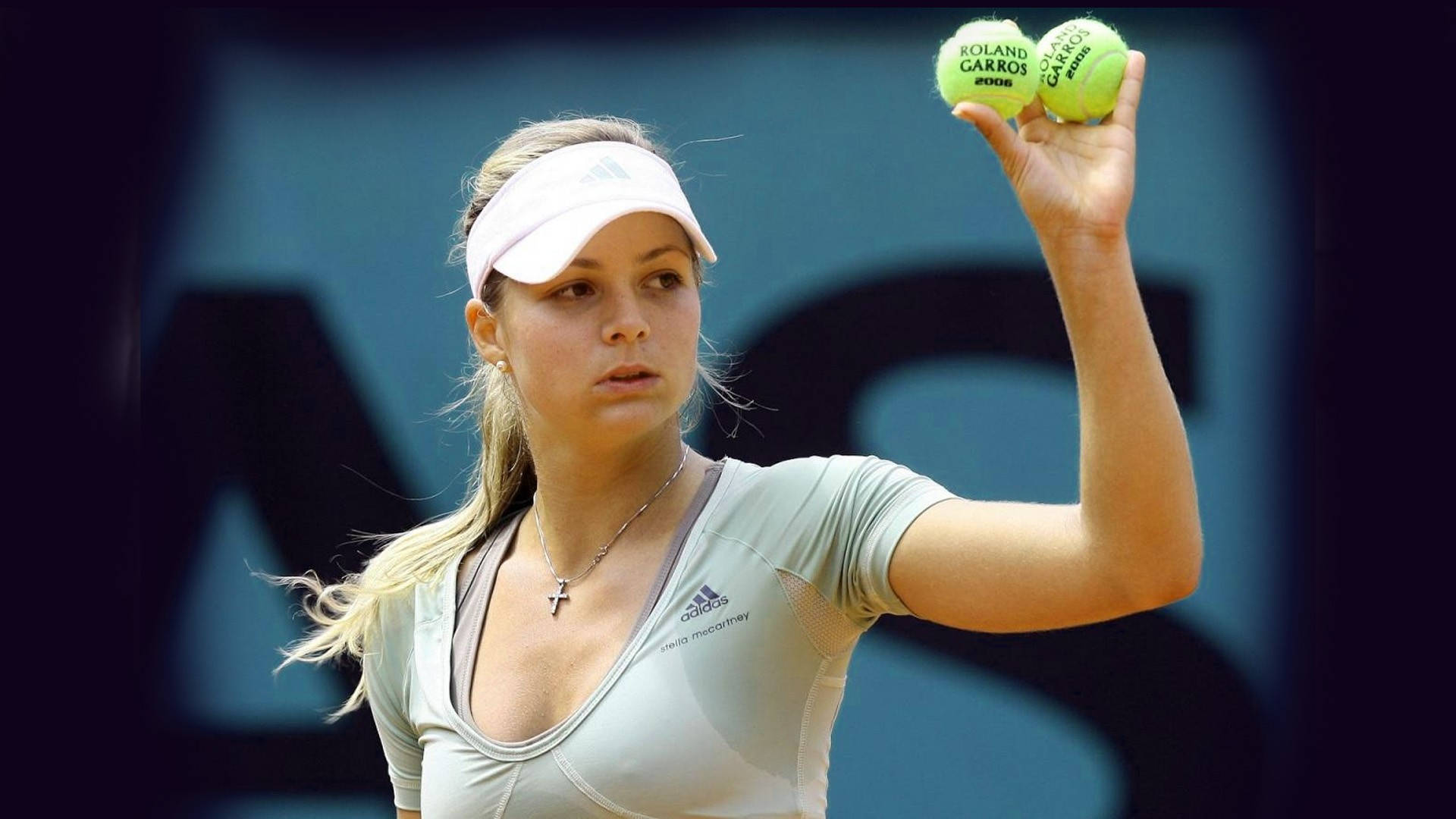 Maria Kirilenko in action with two tennis balls Wallpaper