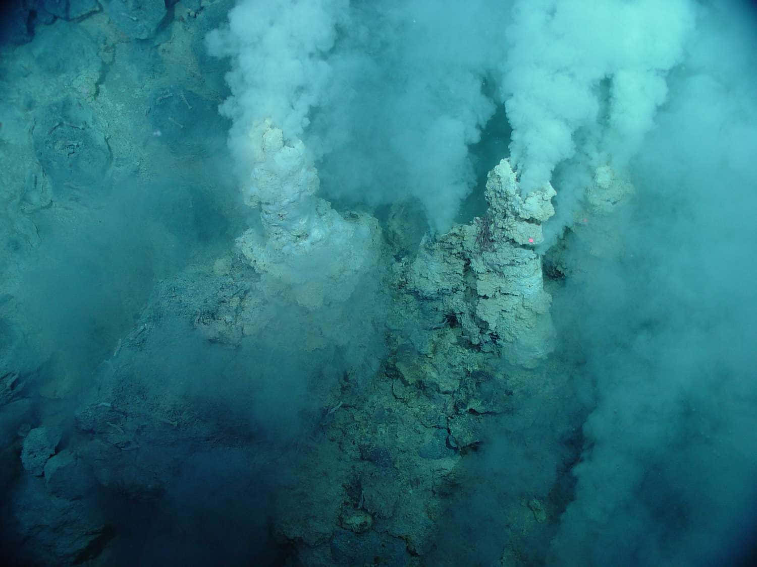 A View Of A Large Crater With Steam Coming Out Of It