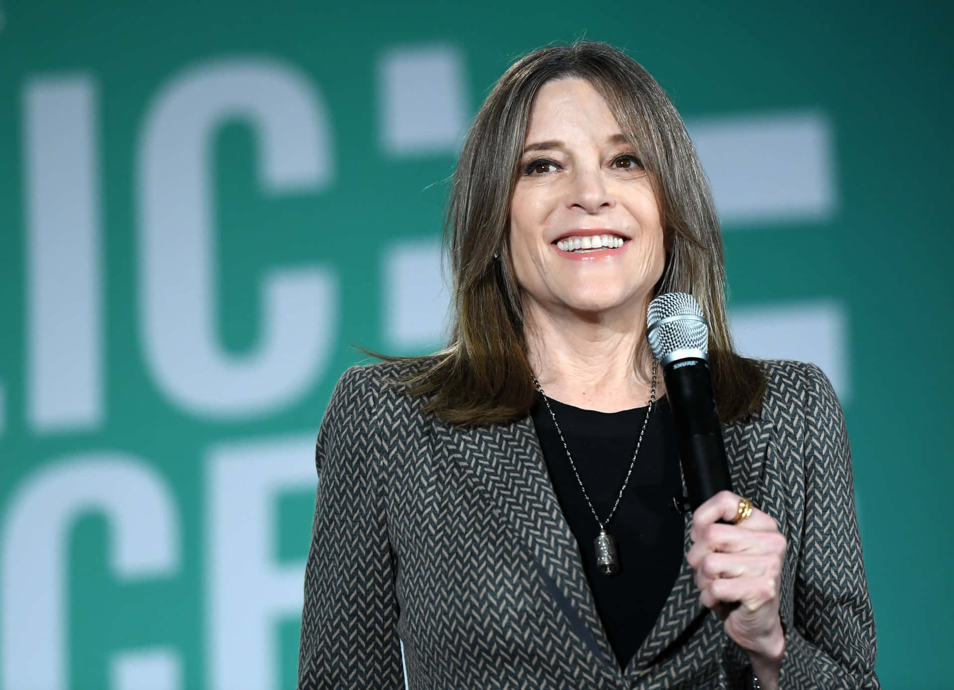 Marianne Williamson Delivering A Powerful Speech Wallpaper