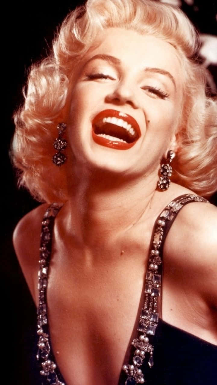 "Marilyn Monroe graces your iPhone screen with her iconic beauty." Wallpaper