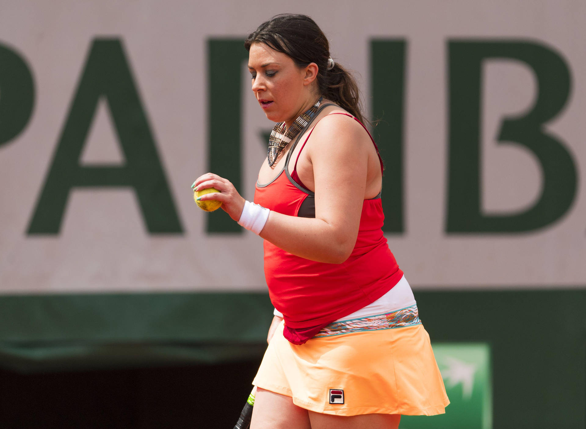 Marion Bartoli shimmering in a vibrant red and orange tennis outfit. Wallpaper