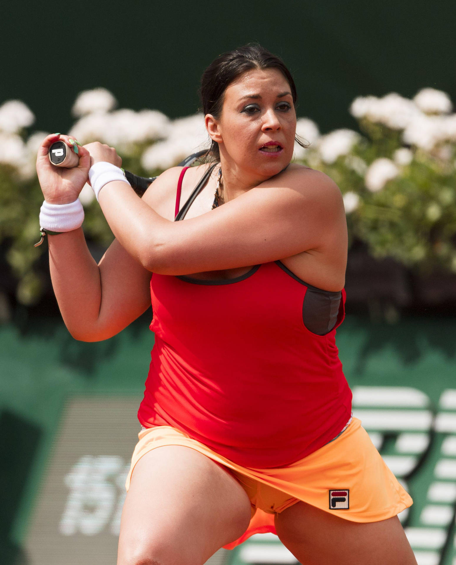 Marion Bartoli during a tennis match in a vibrant red top Wallpaper