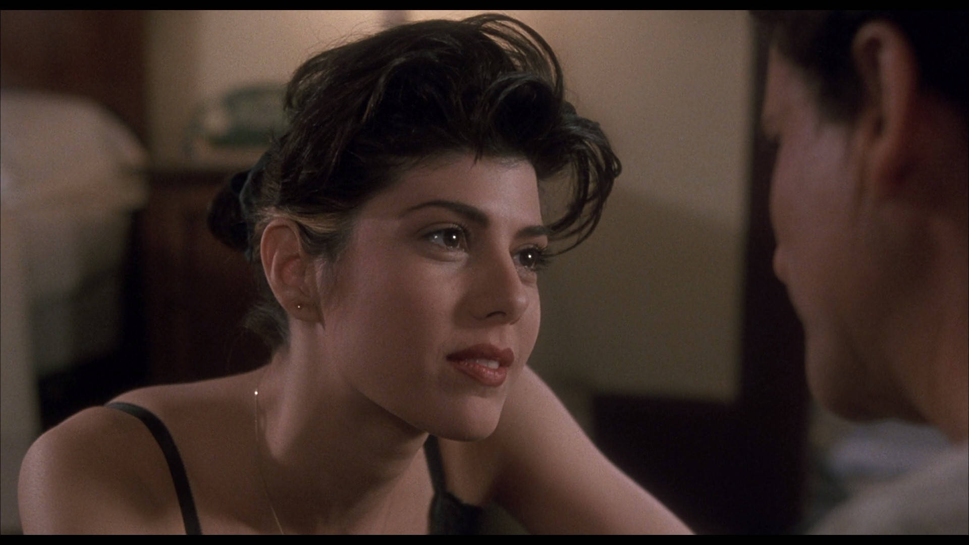 Caption: Marisa Tomei posing artistically, flaunting her stunning undercut hairstyle. Wallpaper