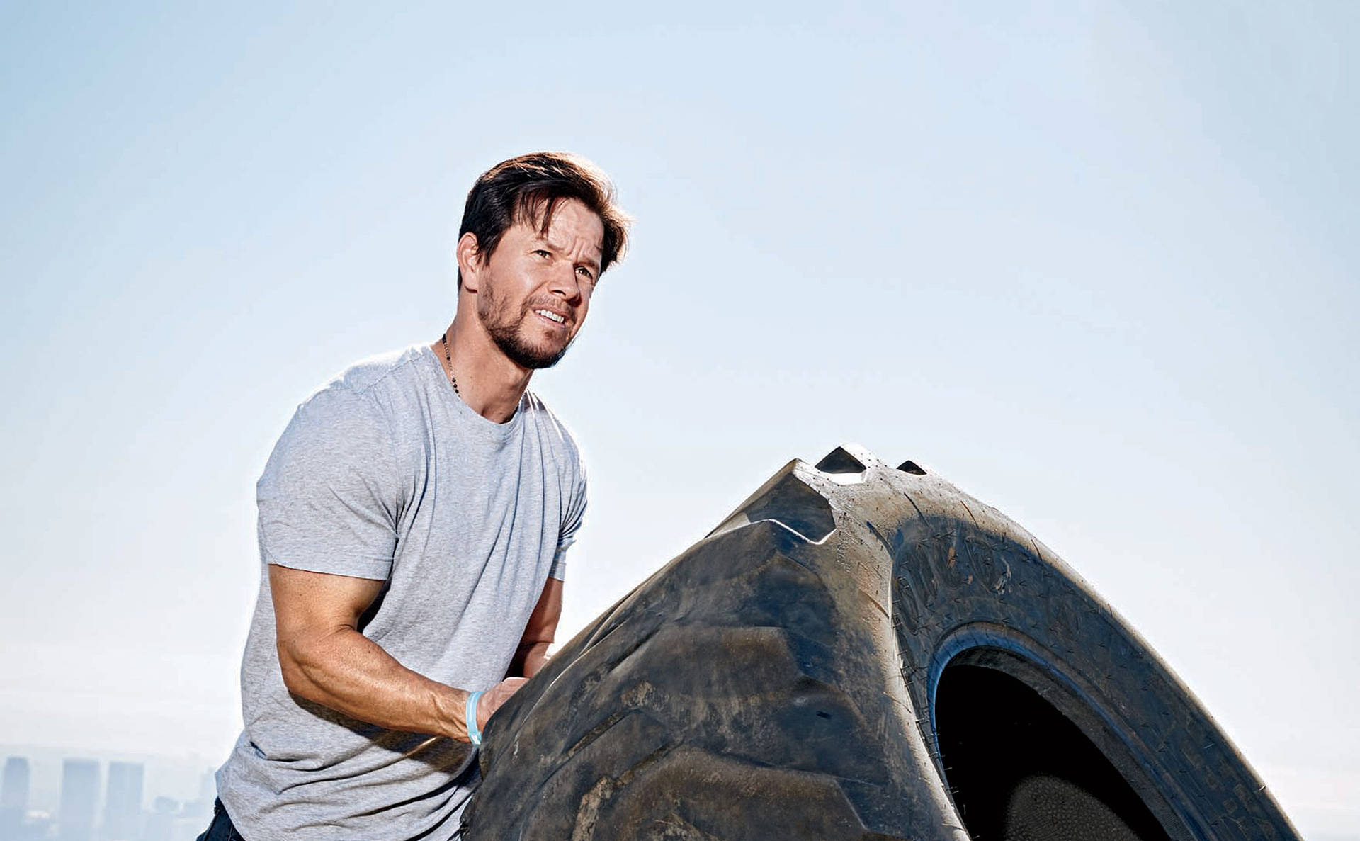 Mark Wahlberg Lifting A Tire Wallpaper