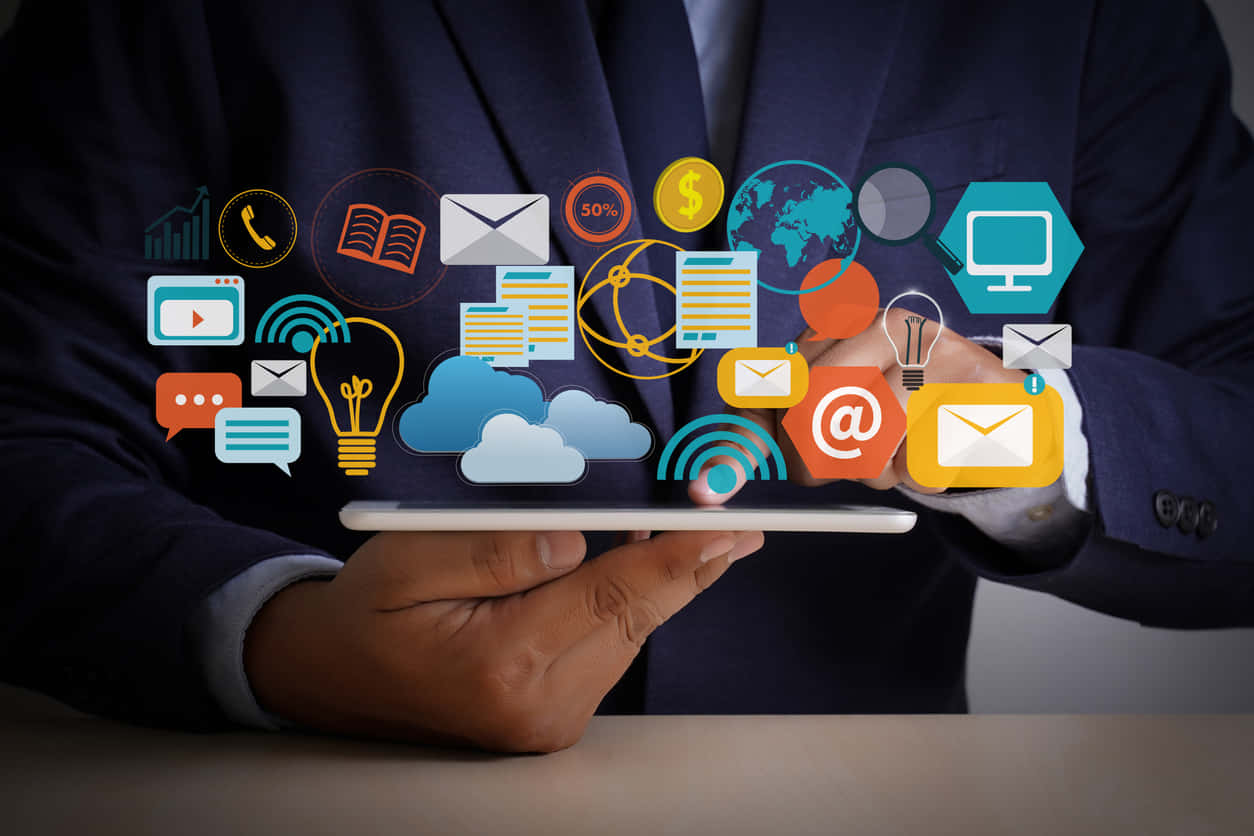 A Businessman Holding A Tablet With Social Media Icons On It Wallpaper