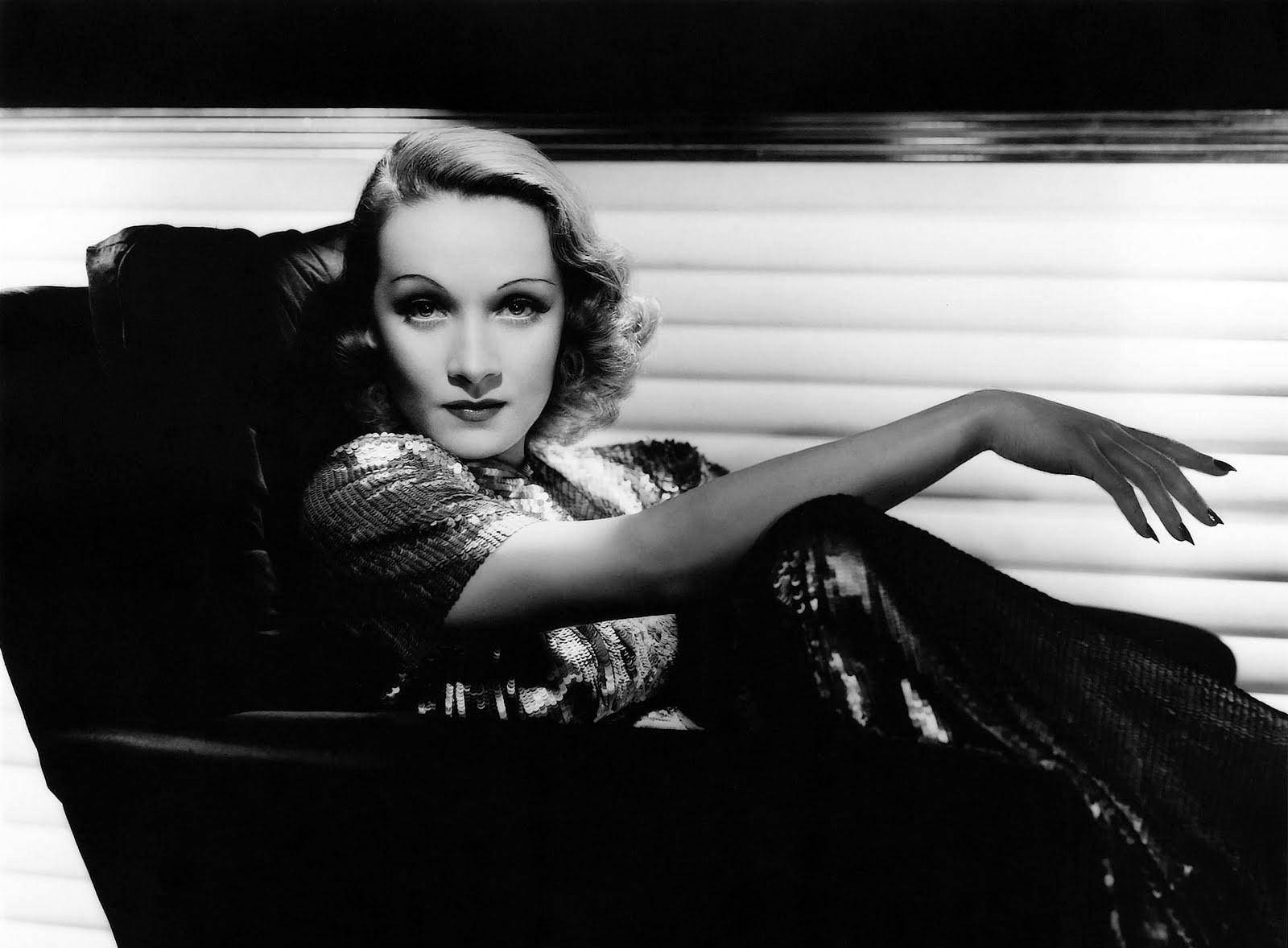 Marlene Dietrich Lounging On Chair Wallpaper