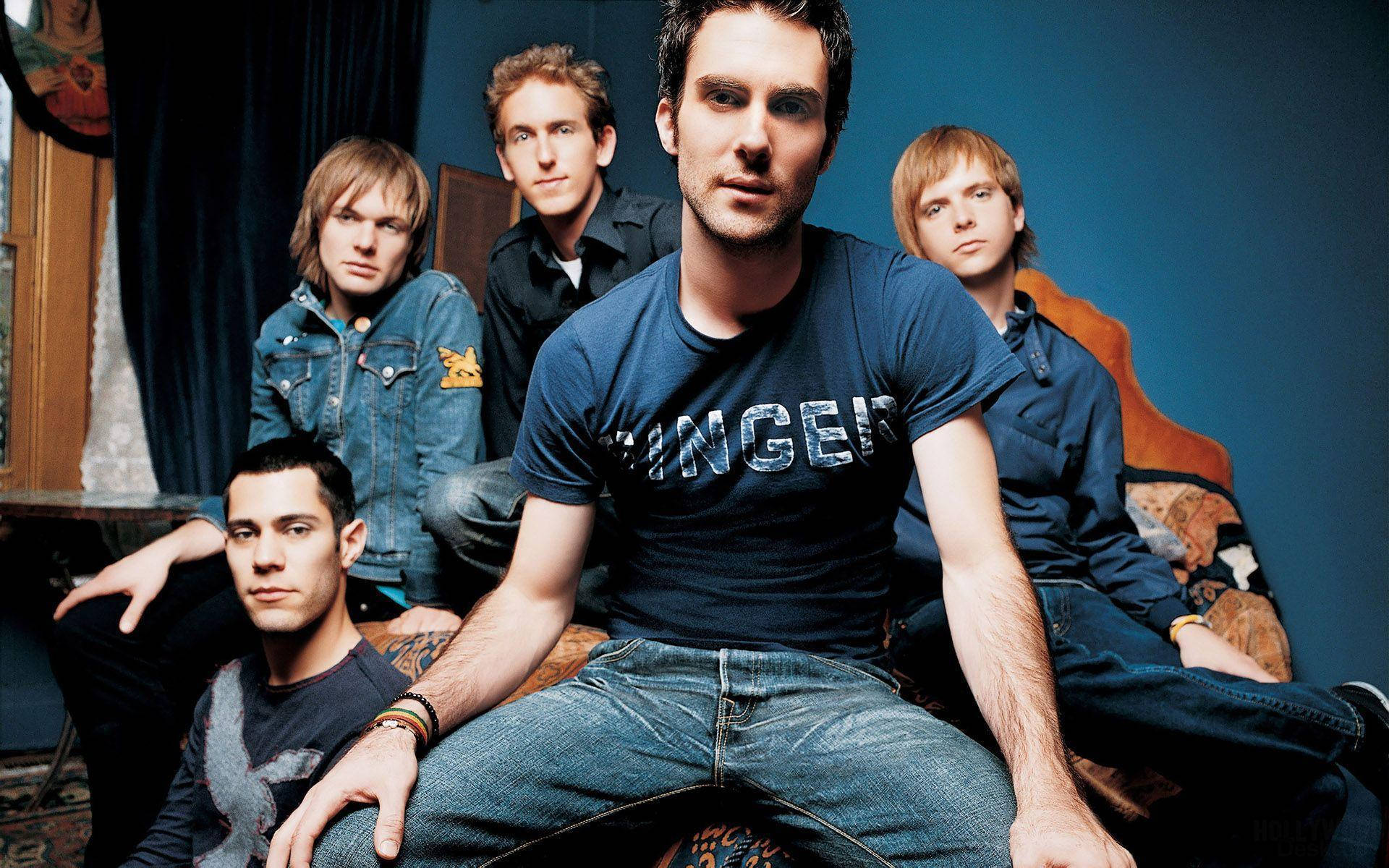 Caption: Maroon 5 Band Members in Blue Ensemble in a Blue Room Wallpaper