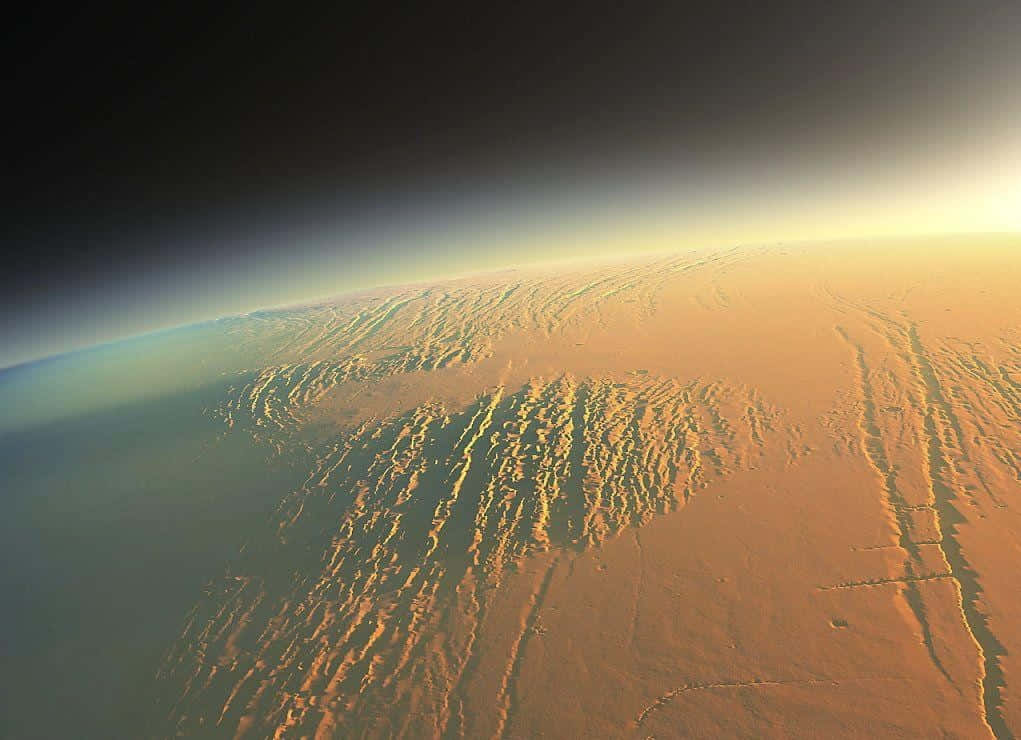 A breathtaking view of the Martian landscape, showcasing the red planet's vast plains and unique rocky formations. Wallpaper