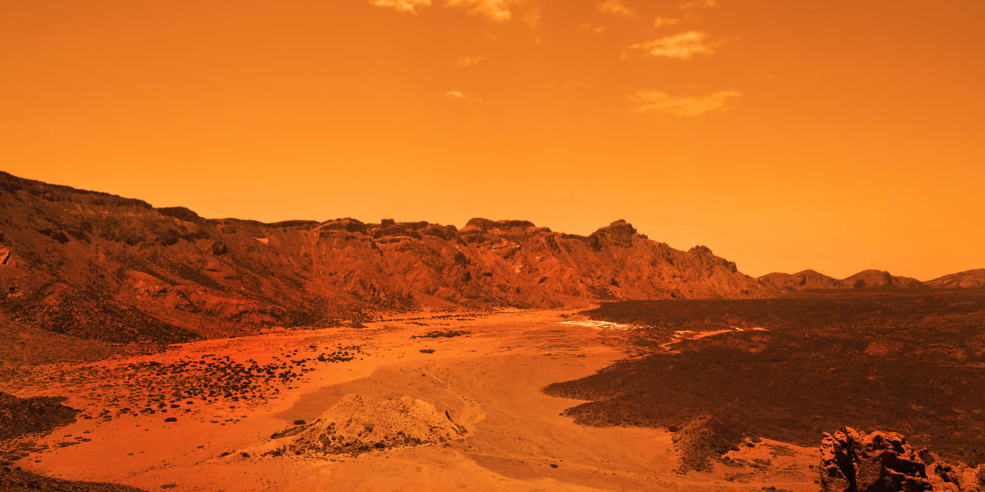 A Desert Landscape With A Red Sky And Mountains