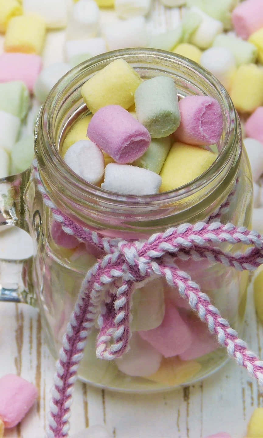 Marshmallows In A Jar On A Wooden Table Wallpaper