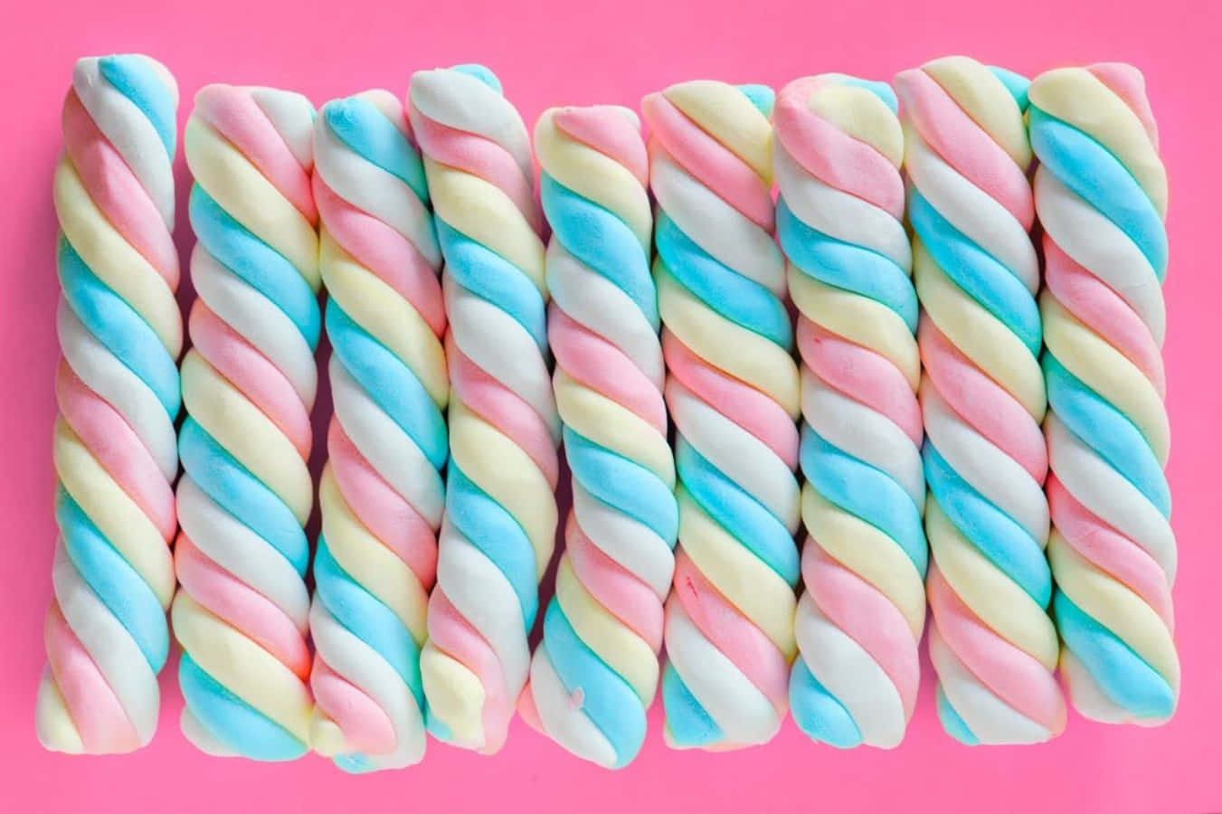 A Bunch Of Candy Floss On A Pink Background