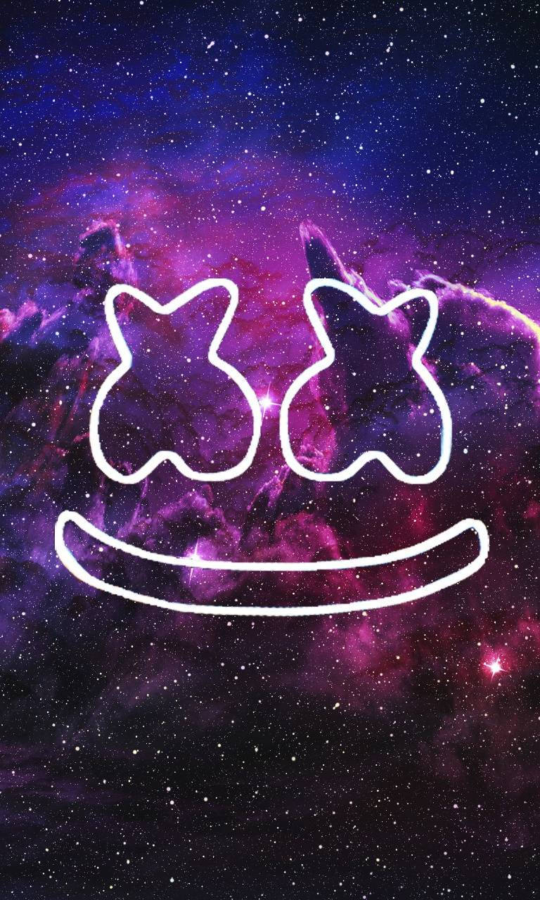 Marshmello playing his hit single Joytime III against the backdrop of a cosmic blue-purple galaxy Wallpaper