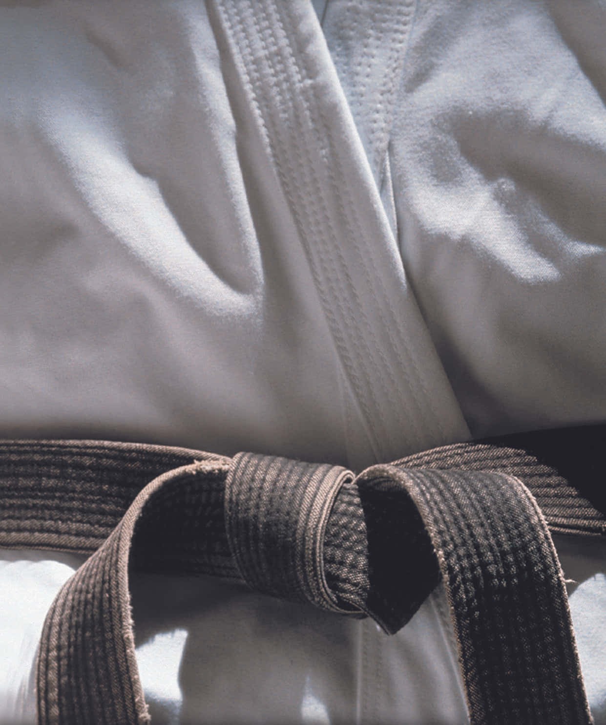 Martial Arts Master Wearing a Traditional Gi and Black Belt Wallpaper