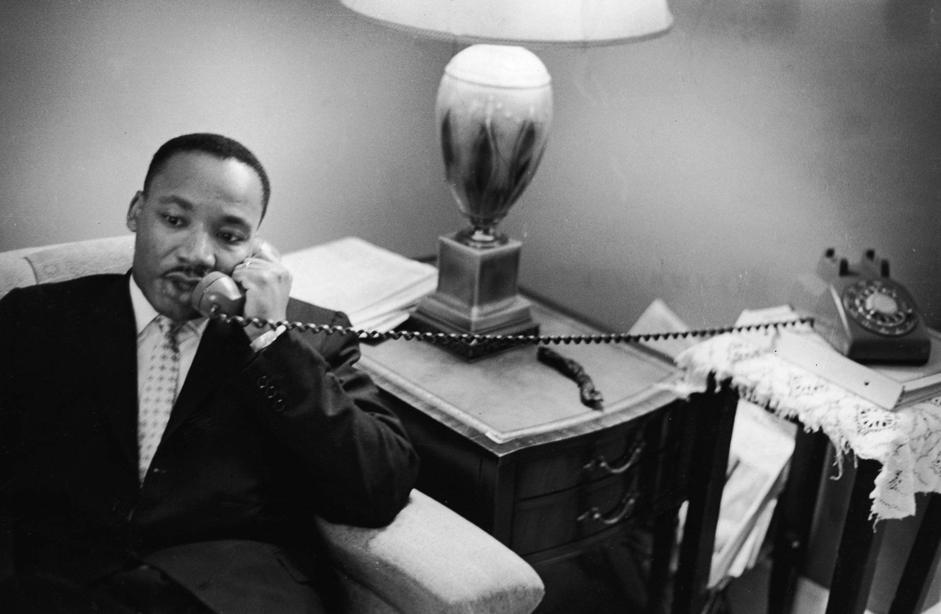 Martin Luther King Jr. Engaging in a Thought-Provoking Phone Call Wallpaper