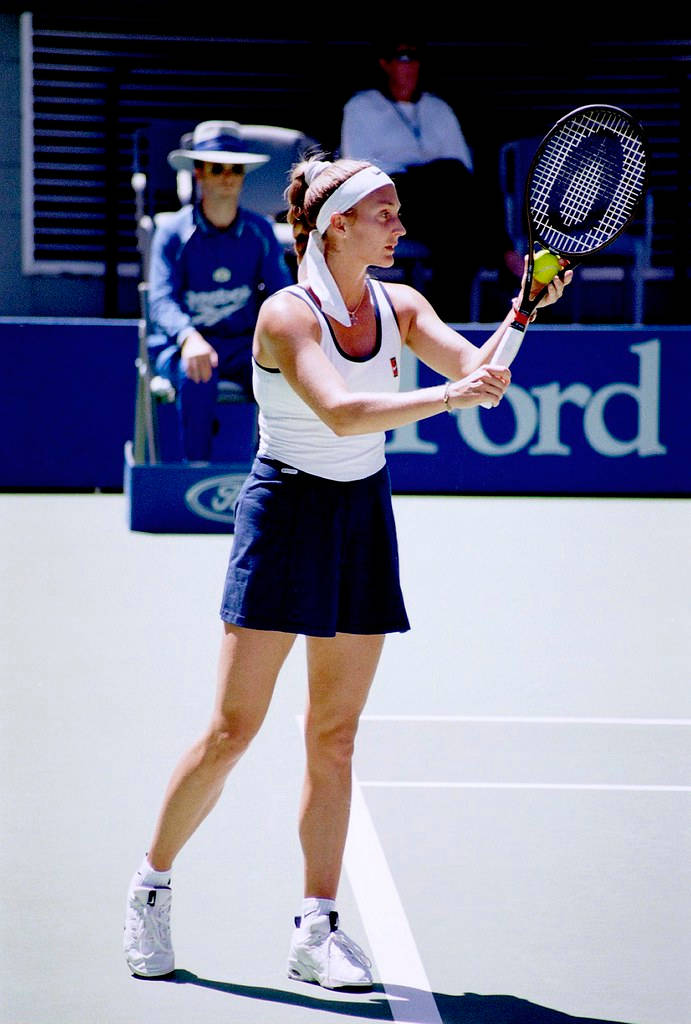 Former Tennis Star Mary Pierce Competing in White and Blue Dress Wallpaper