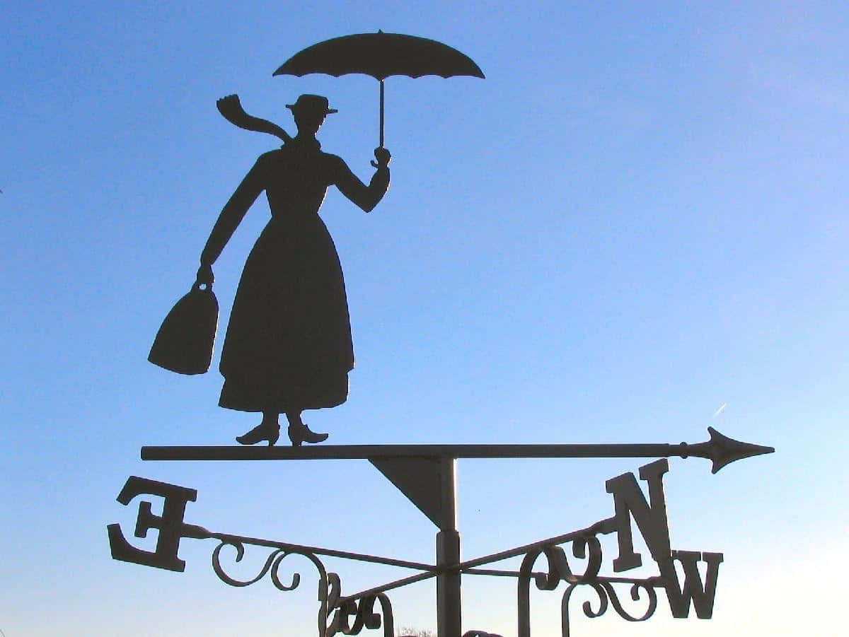 Mary Poppins with her magical umbrella flying over London Wallpaper