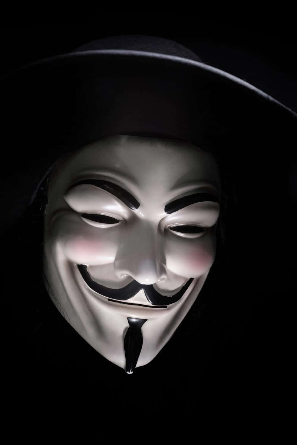 A V For Vendetta Mask Is Shown Against A Black Background