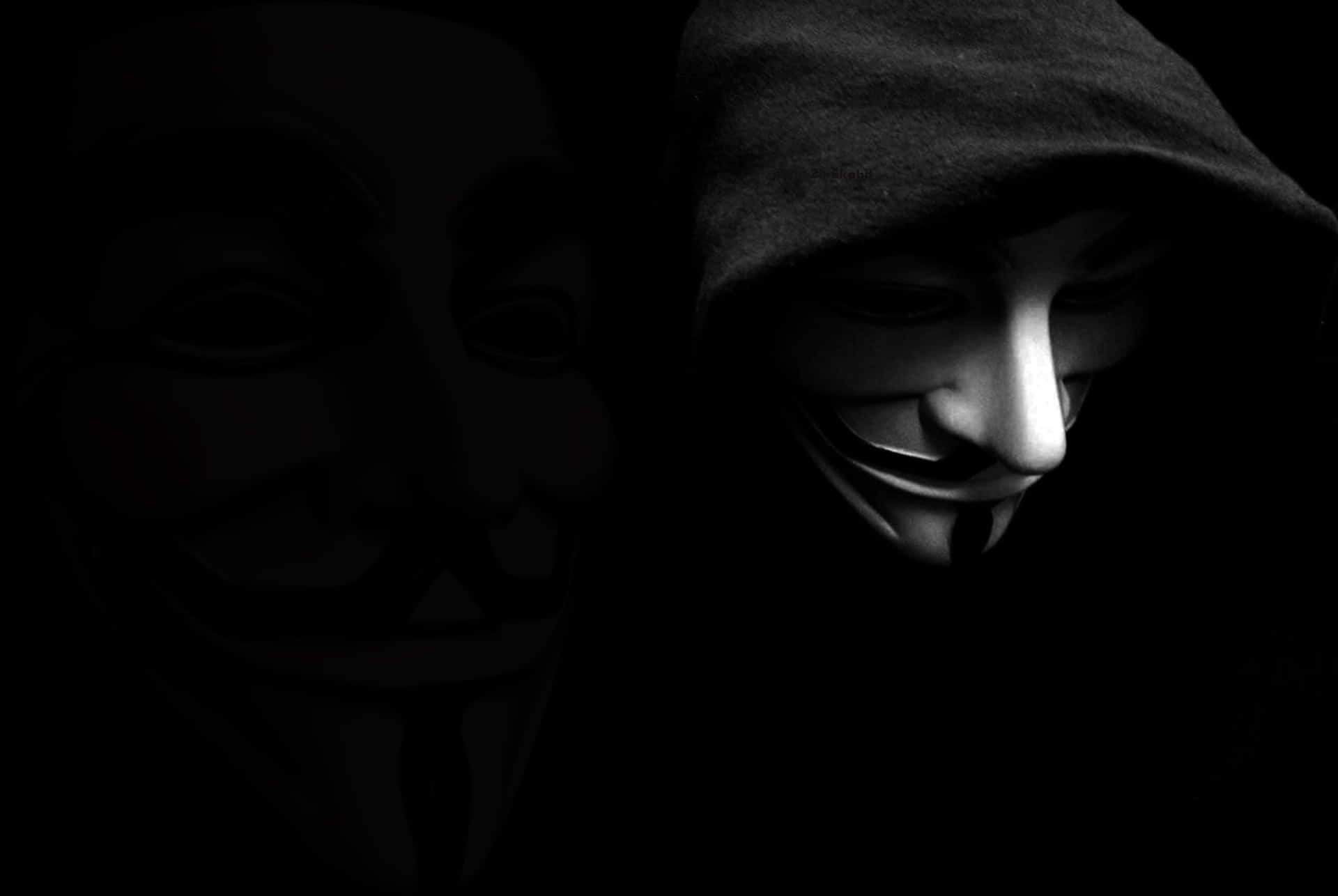 A Black Background With A Hooded Man In A Mask