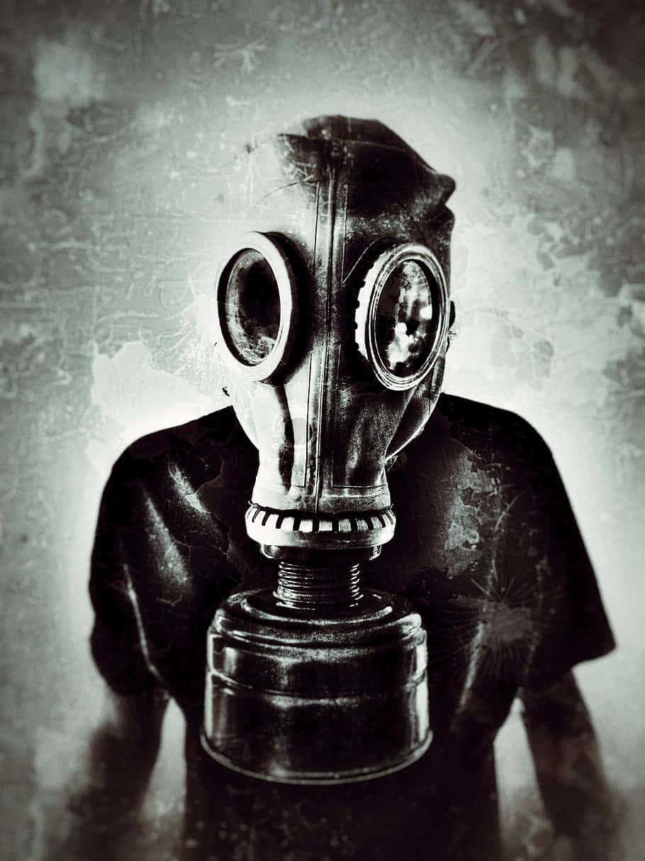 A Man In A Gas Mask Is Holding A Gun