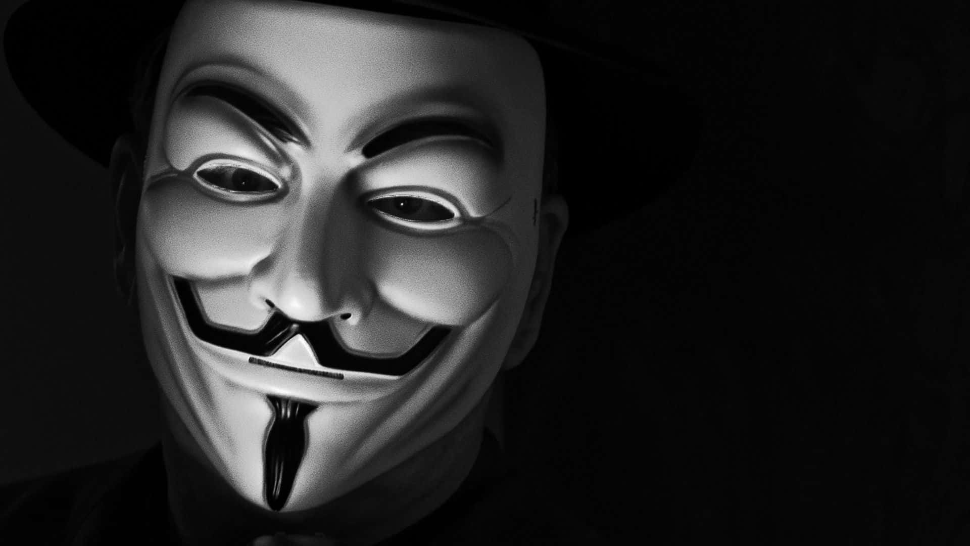 A Man In A Hat And A Mask Is Wearing A V For Vendetta Mask