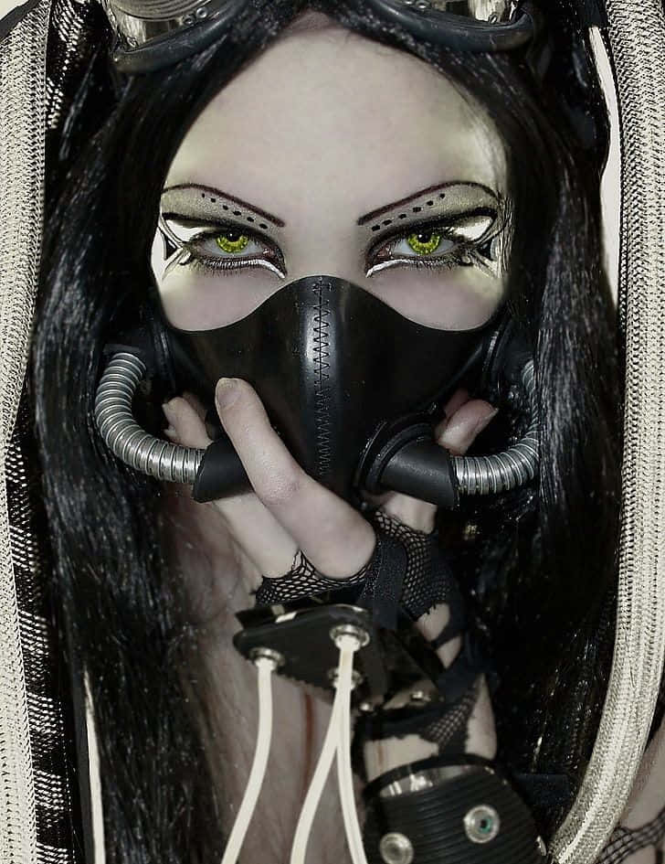 A Woman With Black Hair And A Gas Mask