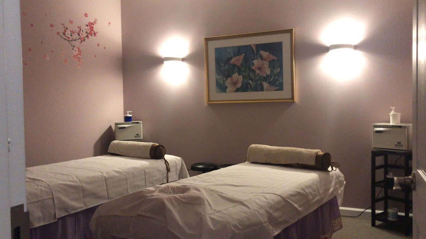 Two Massage Beds In A Room With A Light