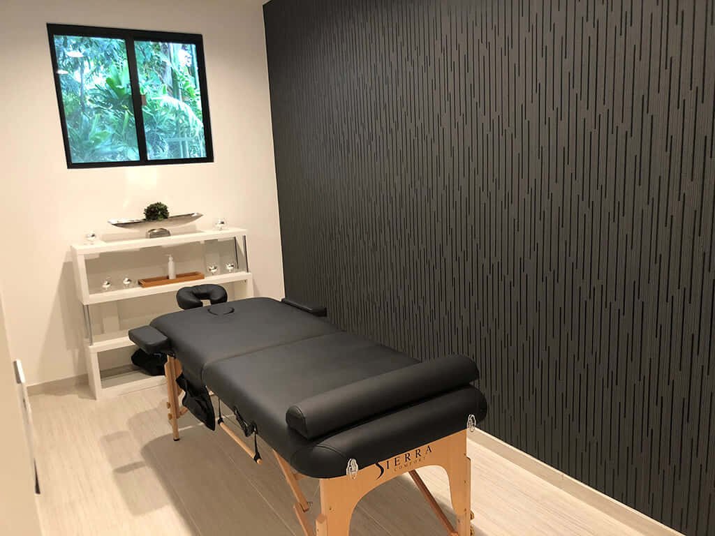 A Massage Room With A Black Massage Table