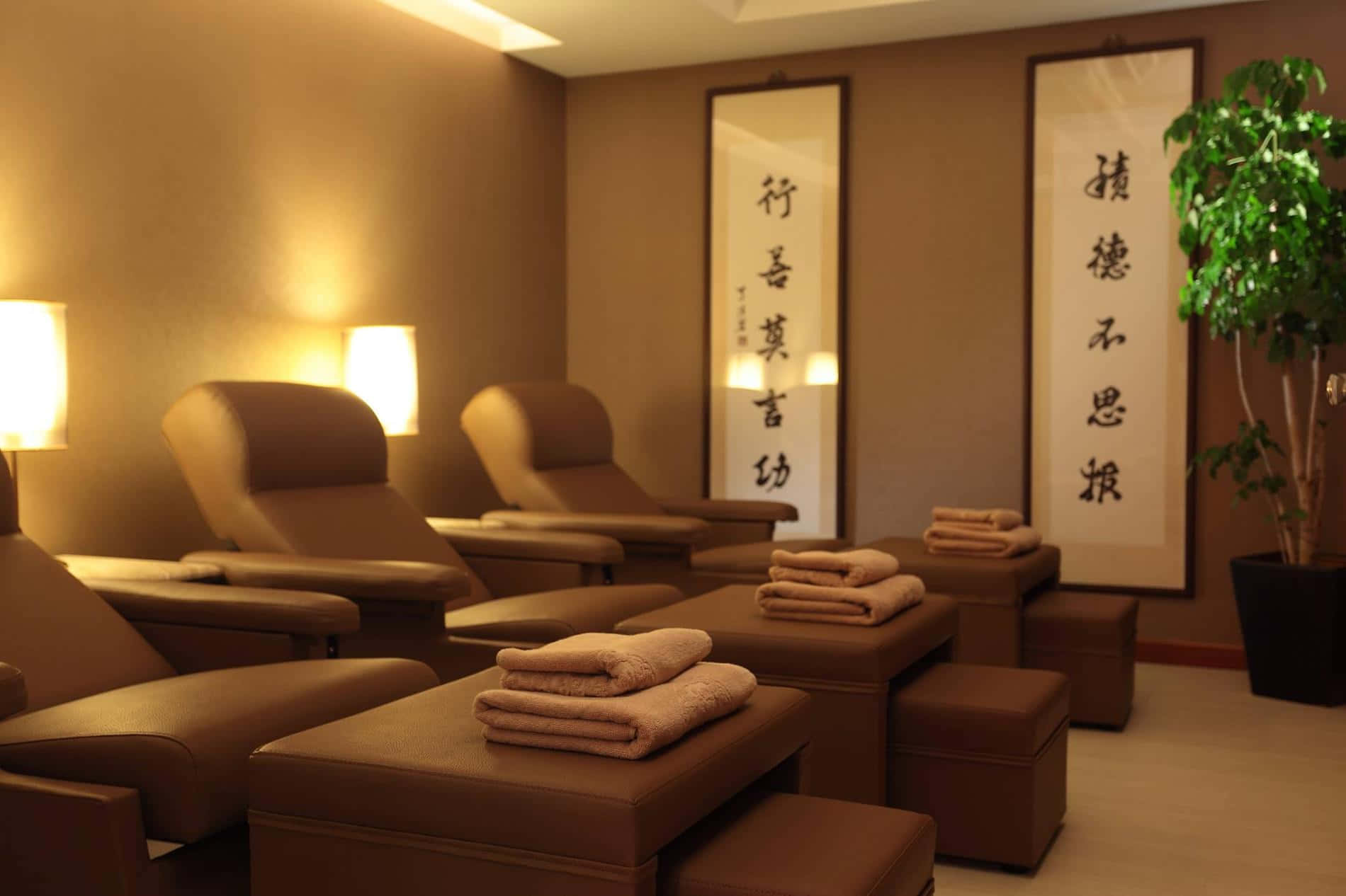 A Spa Room With Chairs And Pillows