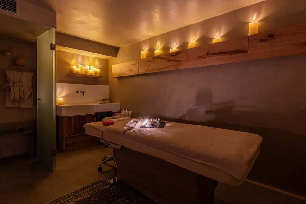 A Room With A Massage Table And Candles