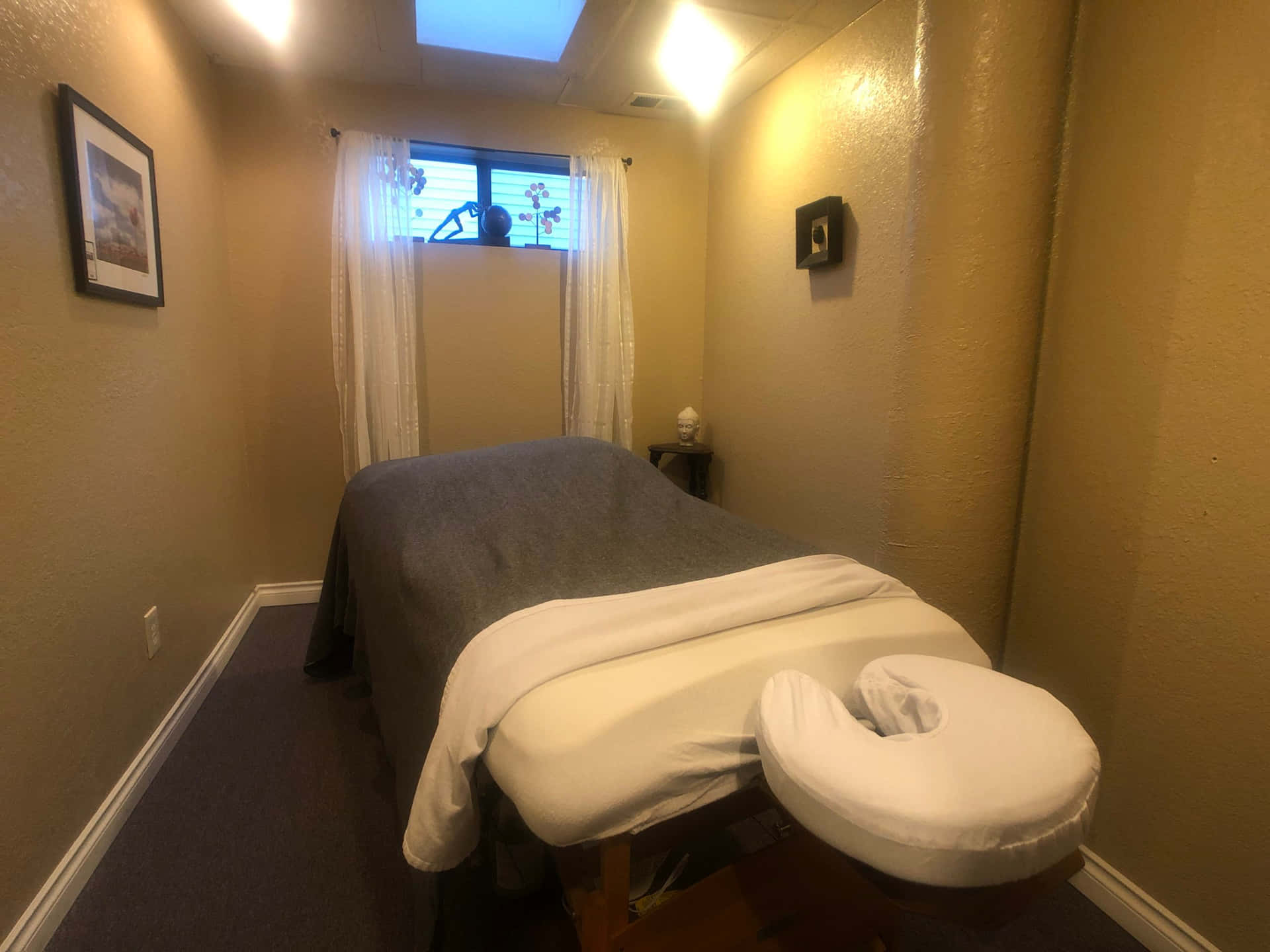 A Room With A Massage Table And A Window