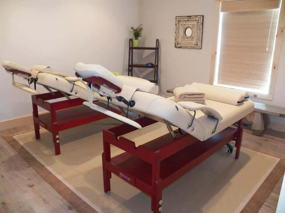 Two Massage Tables In A Room With A Wooden Floor