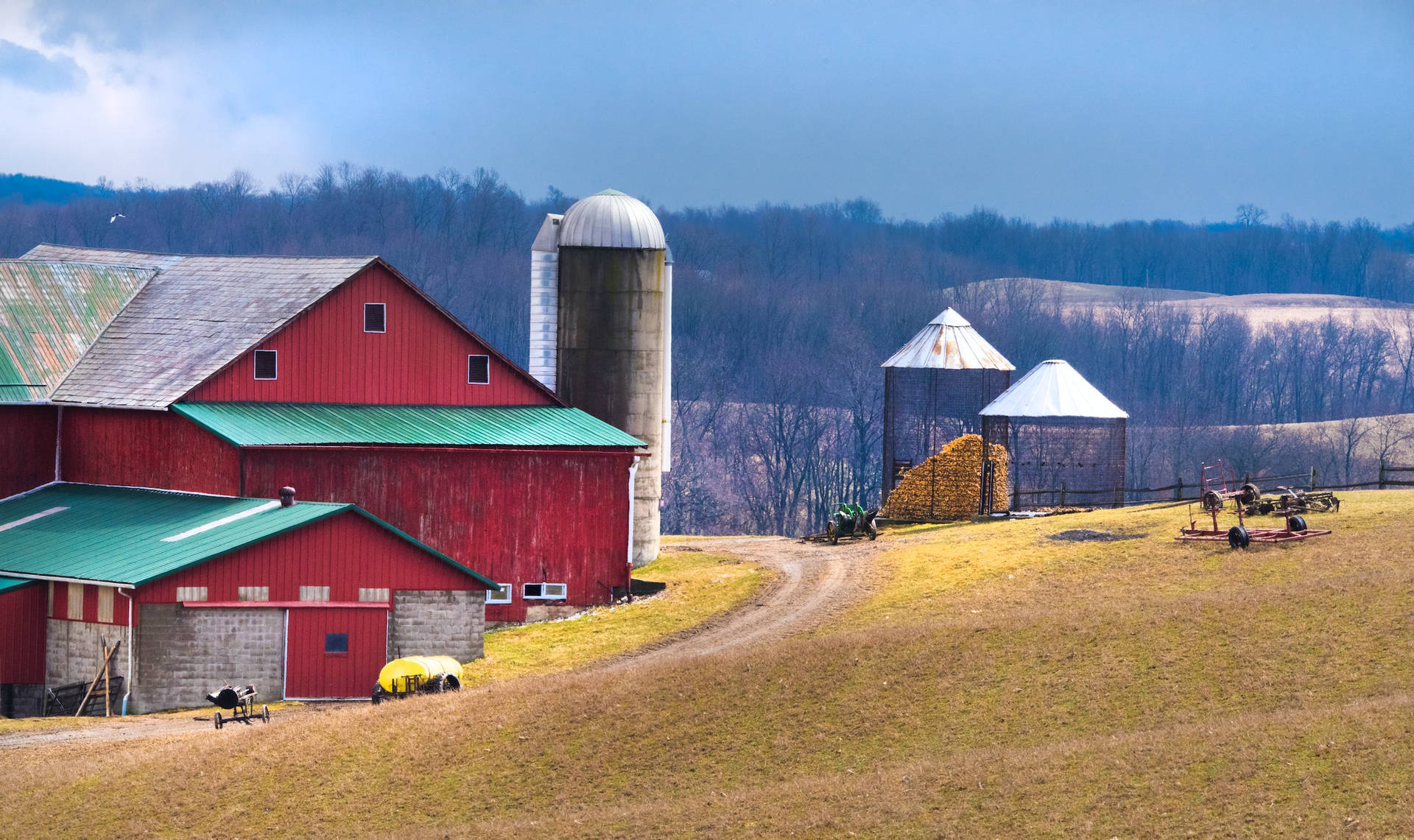 Massive Red Barn In Farm With Large Silo Background