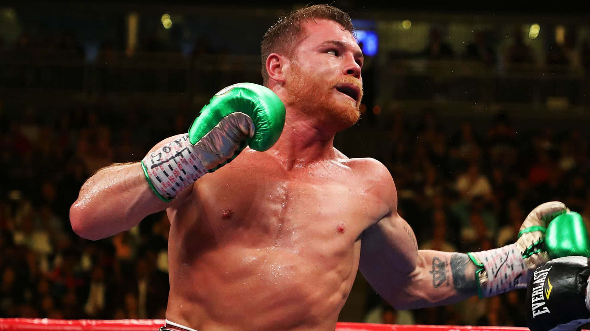 Saul "canelo" Alvarez Delivering A Powerful Punch In The Ring Wallpaper