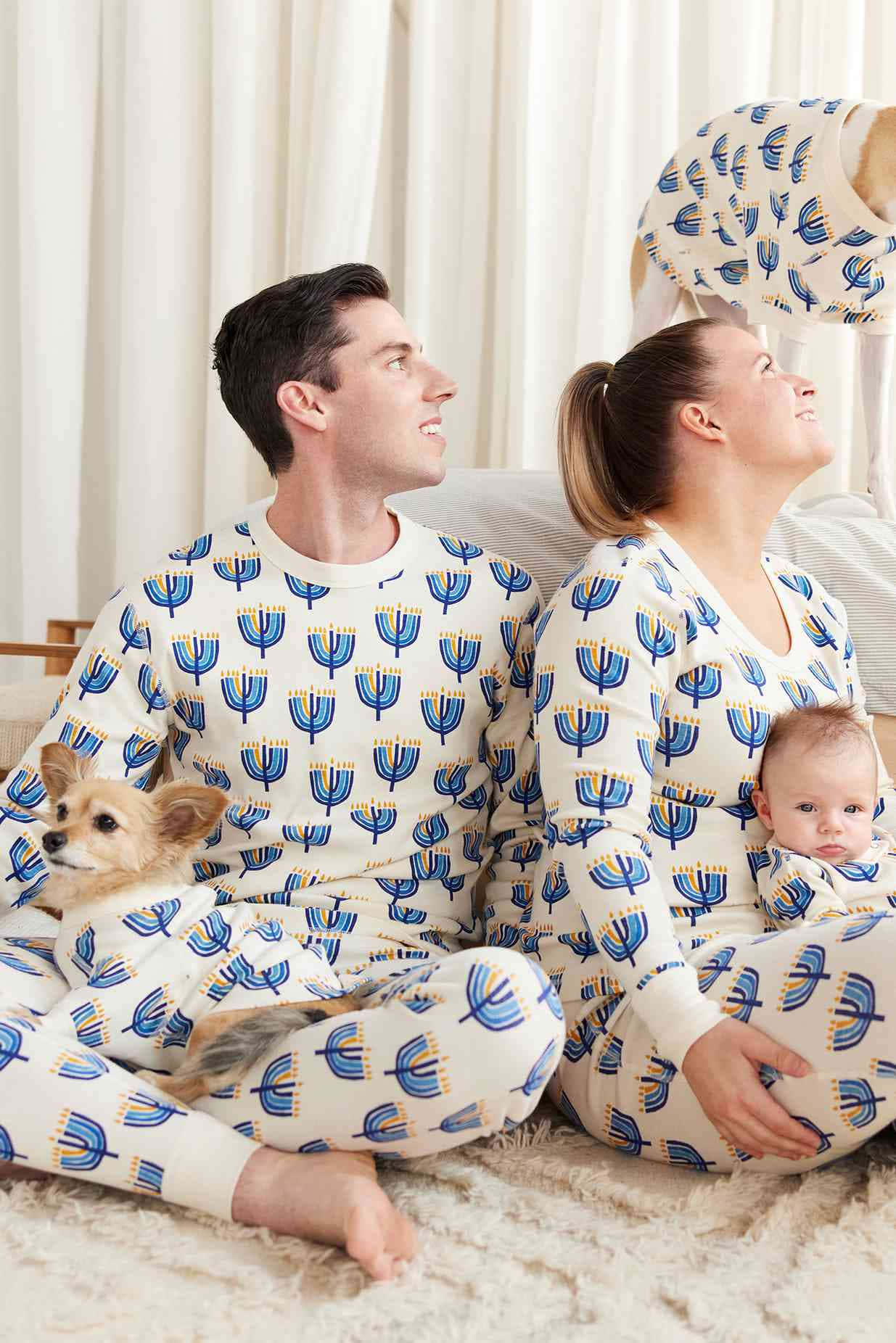 A Family In Pajamas With A Dog