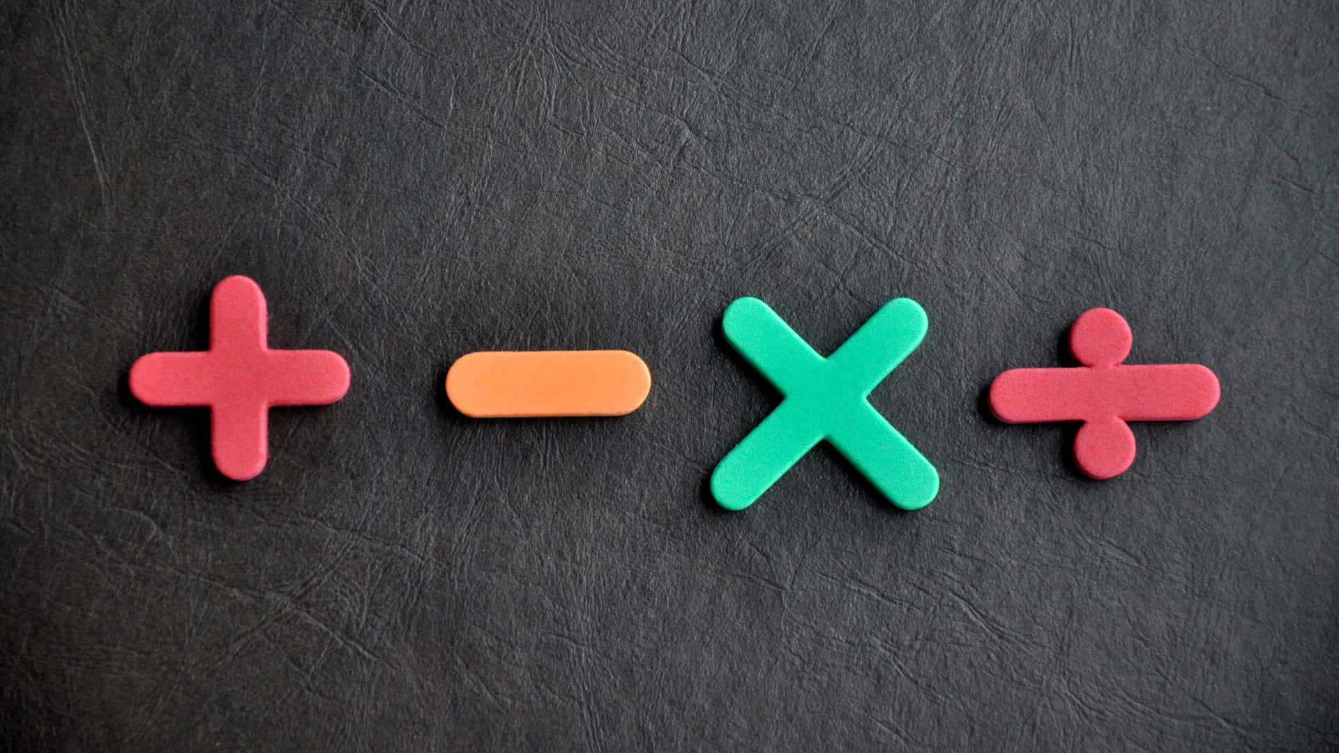 A Set Of Colorful Plastic Numbers On A Black Background