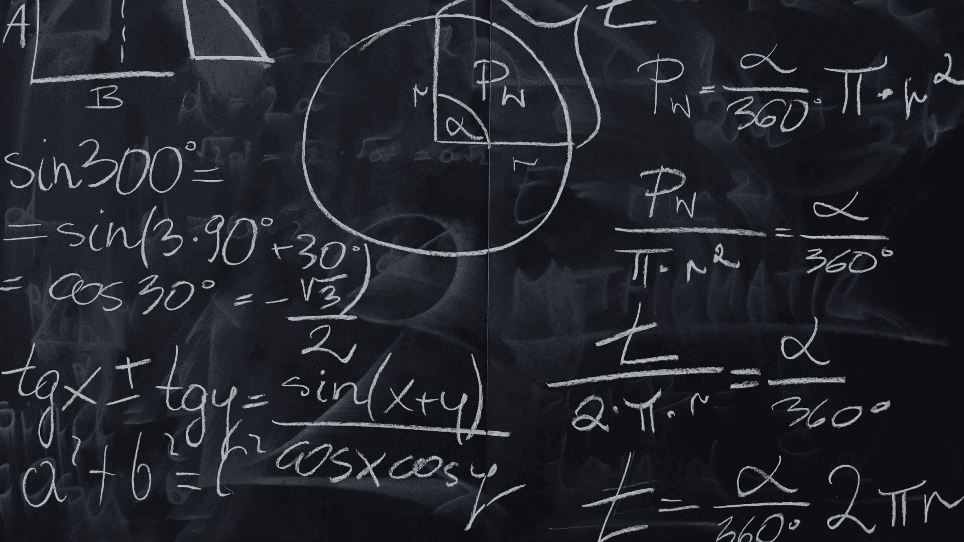 Excel in Mathematics Background — A close-up of a black chalkboard filled with handwritten trigonometric and geometric formulas in white chalk.
