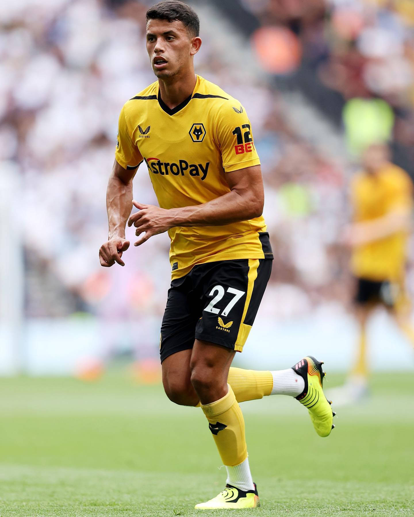 Matheus Nunes in Action in Yellow and Black Uniform Wallpaper